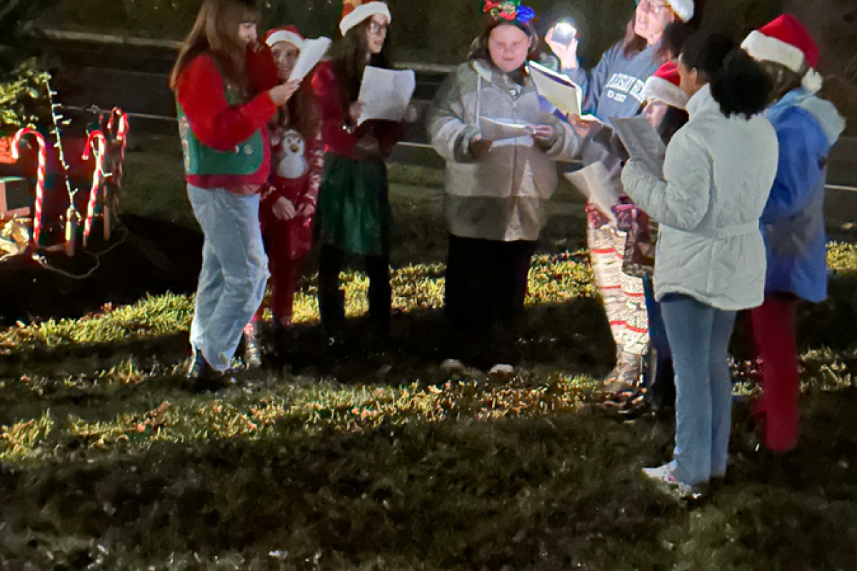 Group of ladies from Girl Scouts singing carols