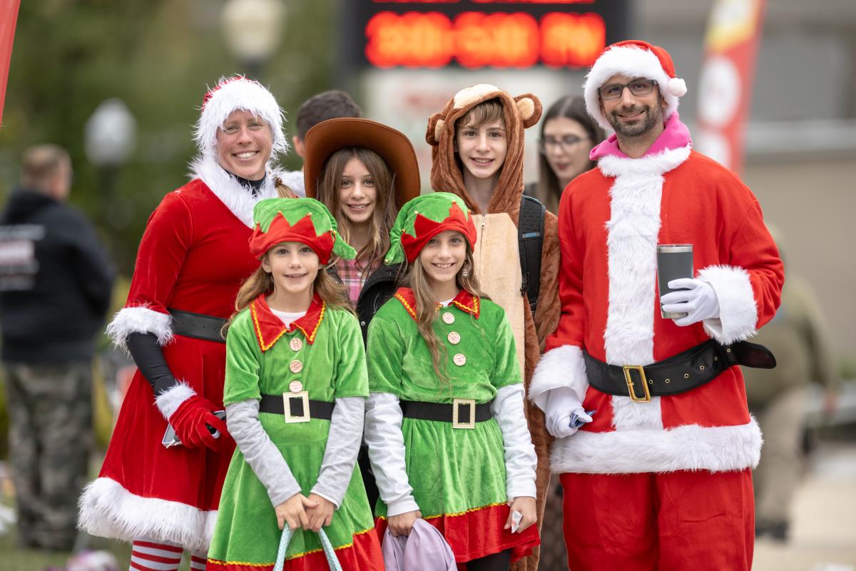 Group of adults and children dressed in Christmas costumes