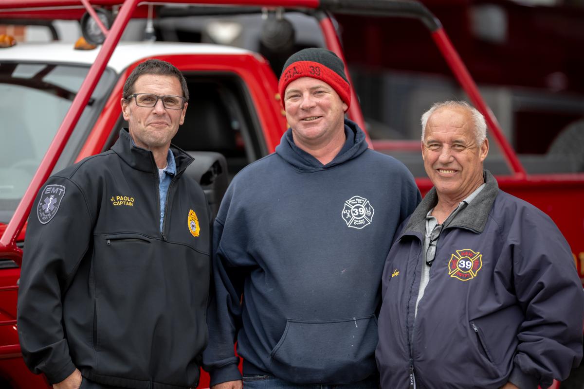 Few of our firemen in front of one of their trucks
