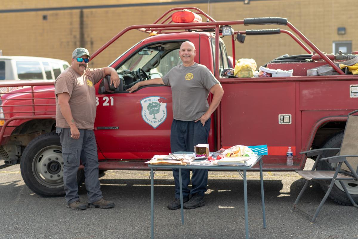 New Jersey Forest Fire Service red Truck with two members posing with it