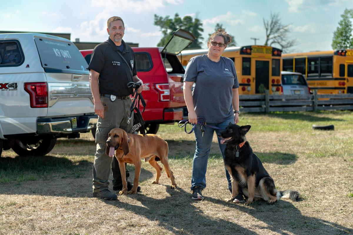 Dog trainers with a couple of their rescue dogs