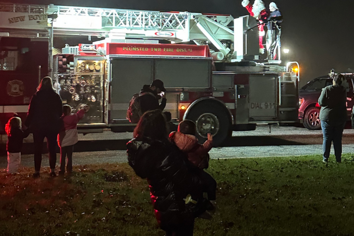Santa arriving via fire truck to tree lighting event