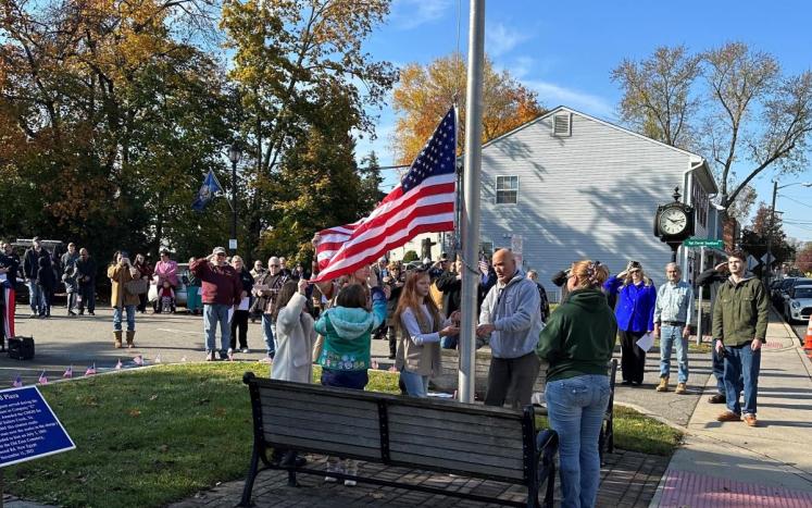 Girl Scouts lowering flag